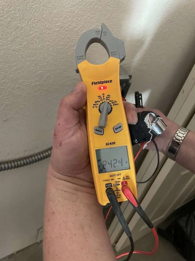 Voltage testing with clamp meter during Outlet Installation in Marana